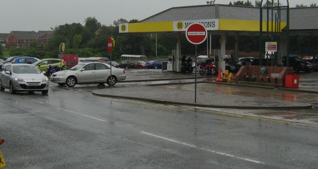 a petrol station in a dull grey day, in the rain and soaking wet